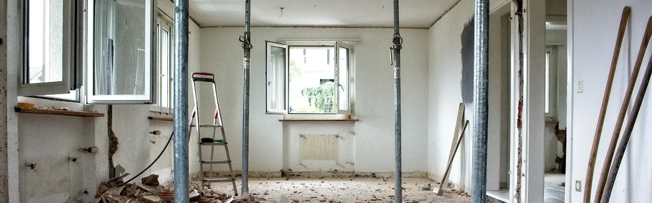Interior room under selective demolition with scaffolding and exposed framing